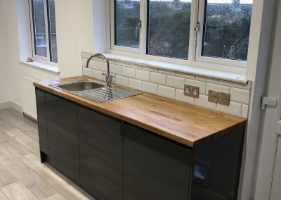 Kitchen sink and cabinet unit by window